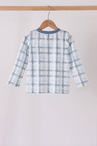 Rear view of blue plaid long sleeve top hanging on hanger with solid blue neckline trim