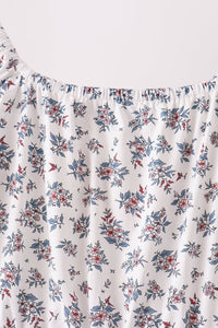 Elastic gathered neckline of white floral mom dress featuring pink blooms and blue leaves.