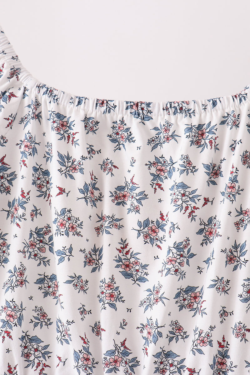 Elastic gathered neckline of white floral mom dress featuring pink blooms and blue leaves.