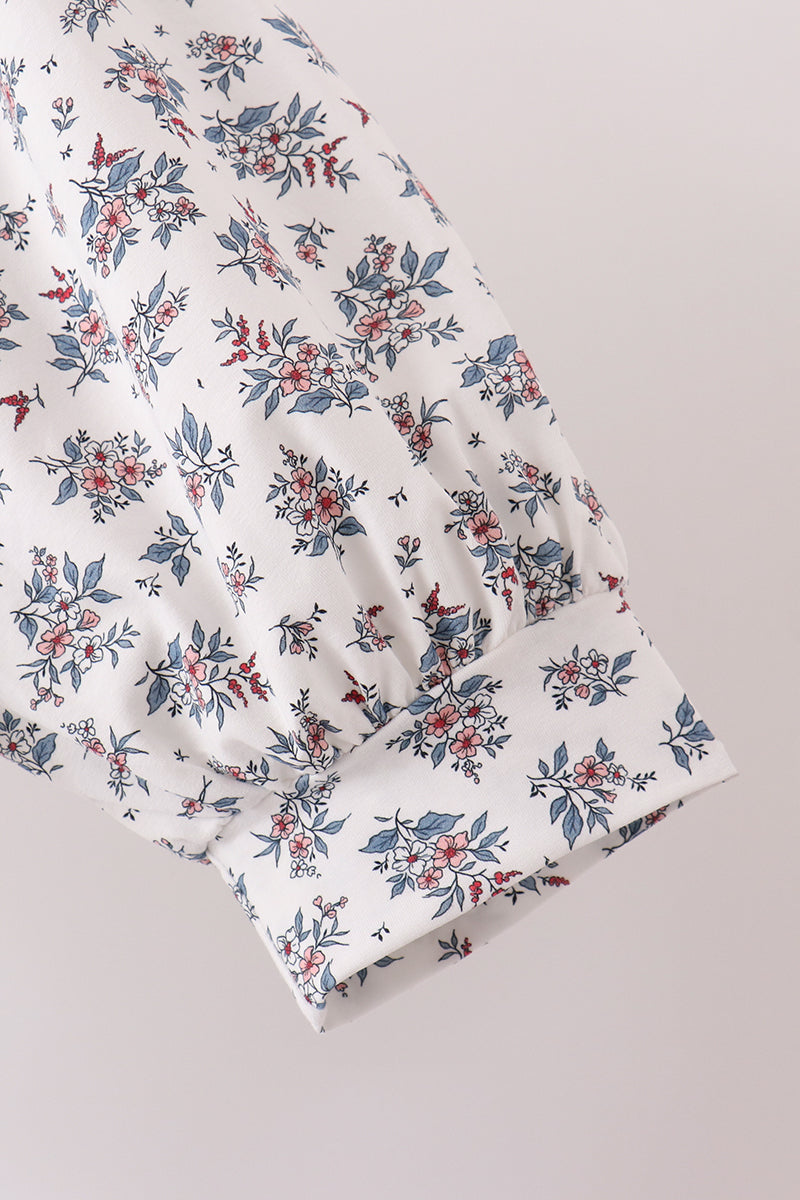 White floral mom dress sleeve featuring pink flowers, blue leaves, and red berries with a gathered cuff for effortless elegance.