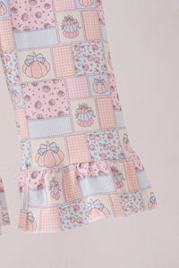 Pink pumpkin patchwork ruffle sleeve detail on a soft fall-themed kids two-piece set