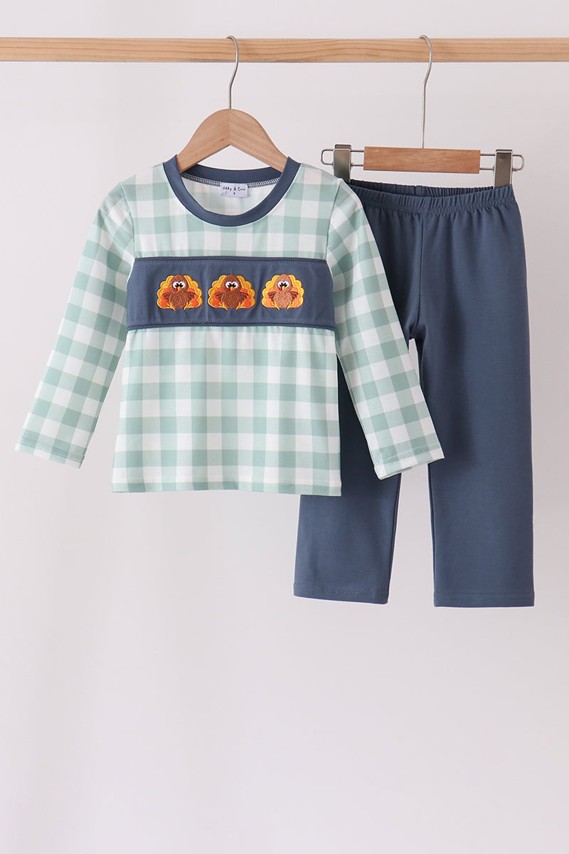 Sage gingham top with navy collar and turkey embroidery paired with solid navy pants