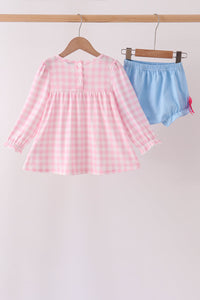 Pink gingham long-sleeve top and blue bloomer shorts set for children. Vintage-inspired outfit with ruffled cuffs and elastic waist.