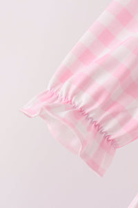 Pink gingham bloomer leg with delicate ruffled elastic cuff. Sweet vintage-inspired fabric detail for festive children's wear.