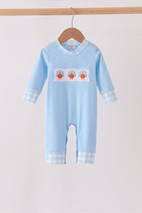 Light blue baby romper with three turkey appliqués across the chest, featuring blue gingham trim on the collar, cuffs, and ankles.