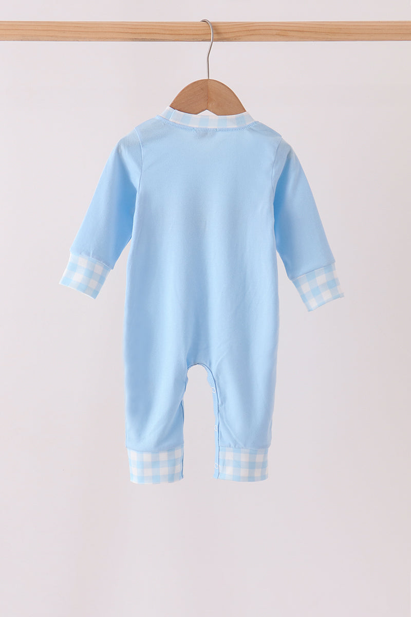 Back of light blue baby romper with gingham cuffs and legs, hanging on a wooden hanger.