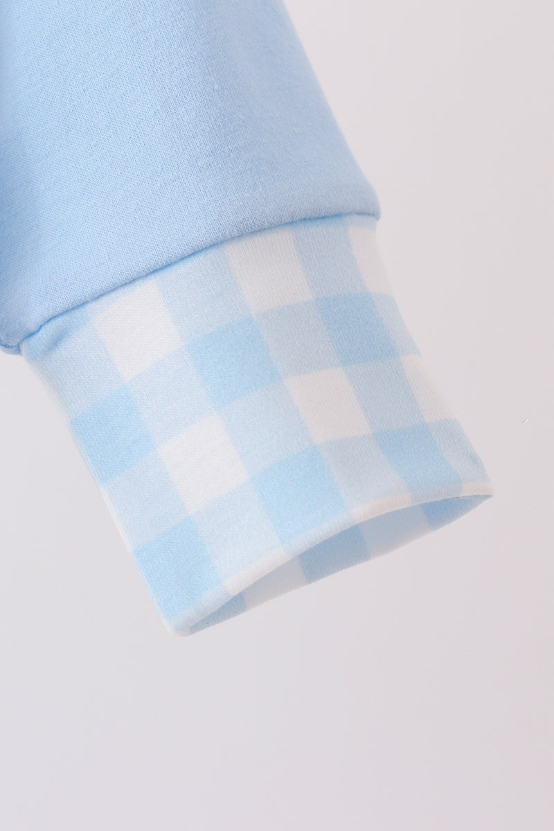 Blue children's romper sleeve featuring soft cotton fabric and a charming light blue and white gingham check cuff detail.
