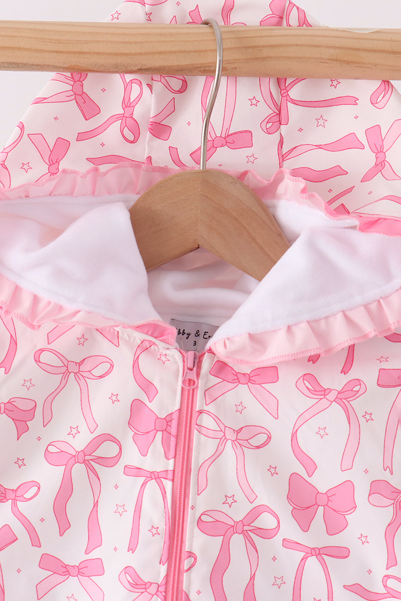 Close-up of white inner lining, pink ruffled hood edge, pink zipper, and Abby & Evie brand tag inside collar