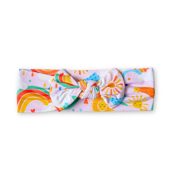 SoftKnot Bow headwrap in Here Comes the Sunshine Pink, bamboo fabric with sun and rainbow print.