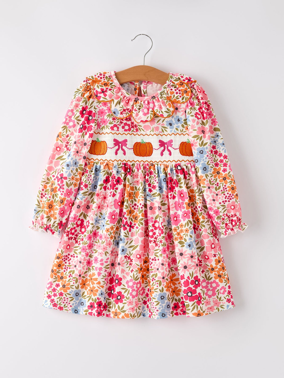 Fall floral dress with pumpkin bow smock embroidery, scalloped collar, and long sleeves.
