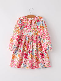 Fall floral smock dress on hanger with vibrant blossoms, long sleeves and gathered waist.
