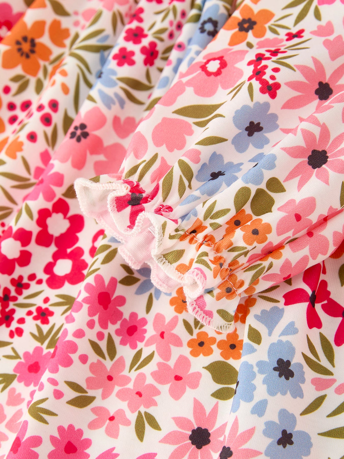 Floral print fabric from Fall Pumpkin Bow Smock Dress with pink, orange, blue flowers and green leaves.