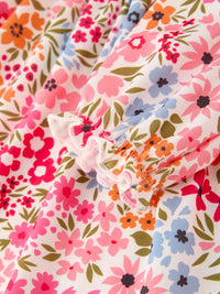 Floral print fabric from Fall Pumpkin Bow Smock Dress with pink, orange, blue flowers and green leaves.