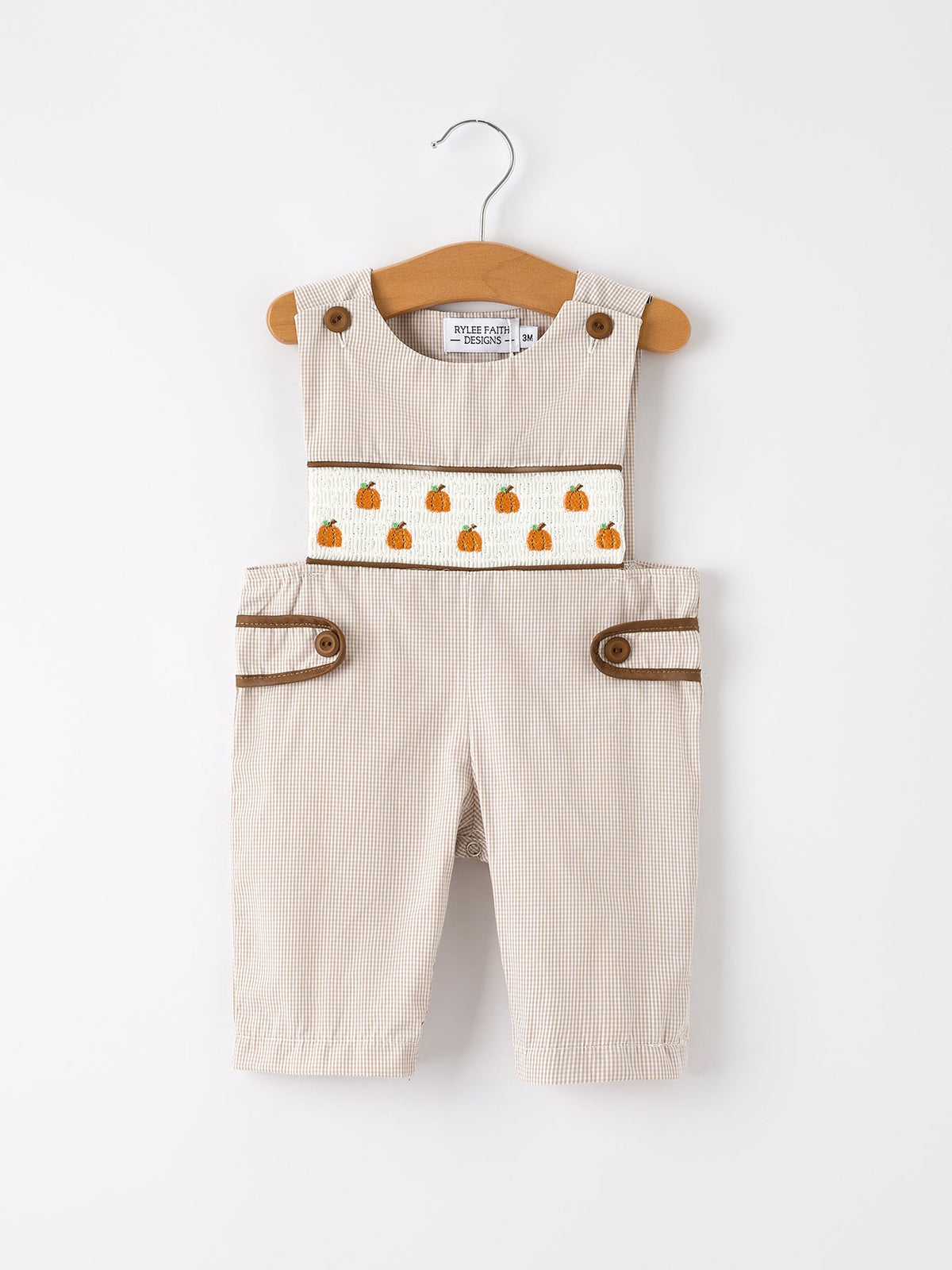 Beige checkered boys romper with pumpkin embroidery on a white smocked panel and brown trim.