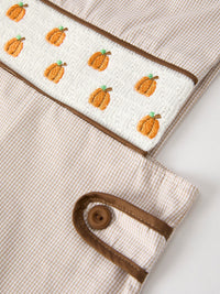 Fall pumpkin smock embroidery on white quilted panel of beige striped boys romper with brown trim