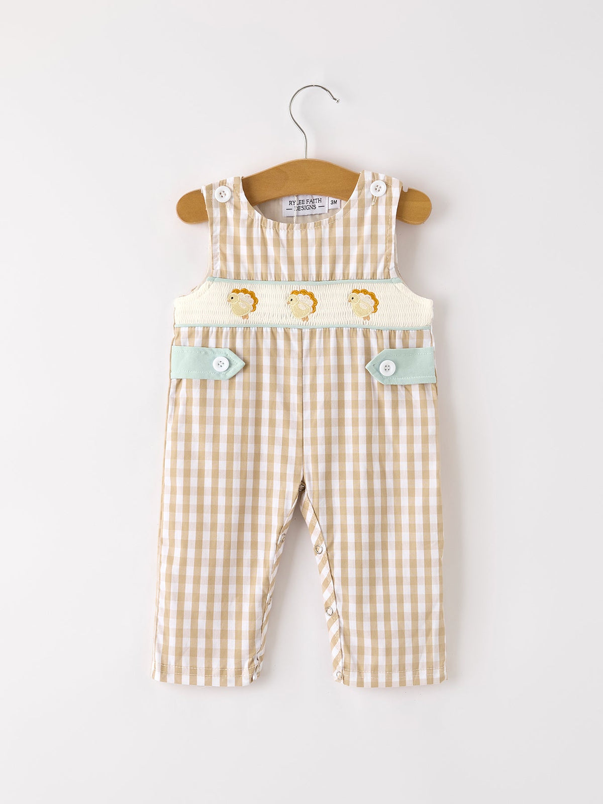 Apricot plaid baby boys romper with smocked chick embroidery, mint green pockets, and side snaps for easy dressing.
