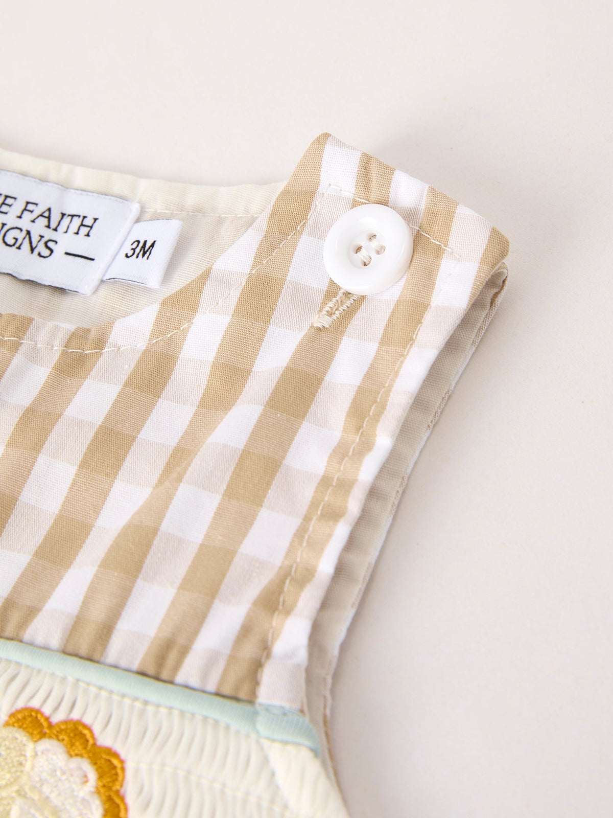 Apricot plaid baby romper strap with white button and smocked chick embroidery detail for Fall Thanksgiving.