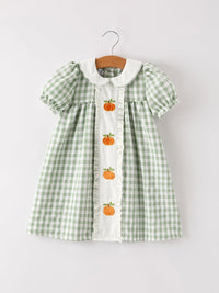 Fall Halloween pumpkin appliques on green plaid dress for girls with a white center panel.