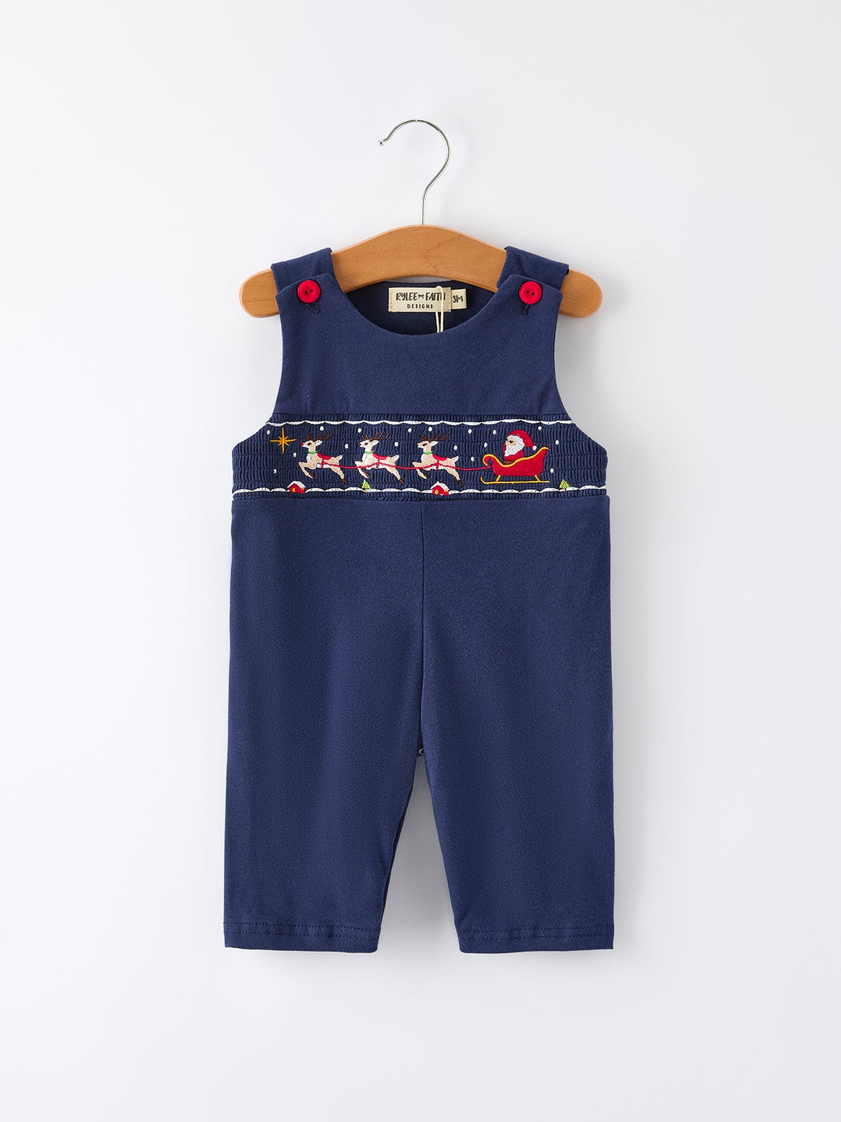 Navy blue baby boy romper with festive Santa sleigh and reindeer smocking on the chest, featuring red shoulder buttons.