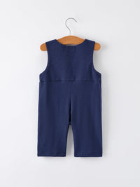 Back view of navy baby boys holiday romper on wooden hanger featuring Santa sleigh design for festive celebrations.