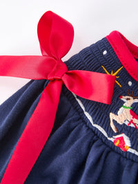 Navy Christmas dress waist with red ribbon bow and festive embroidered Santa sleigh and reindeer motif.