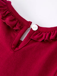 Red girls dress neckline with ruffled collar and white button closure, featuring festive smocking embroidery for holiday wear.