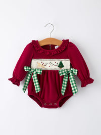 Red baby girl romper with festive Christmas embroidery of a dog and tree, featuring ruffled neckline and green plaid side ties.