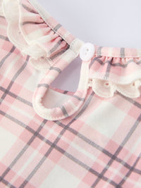 Pink plaid baby girl romper featuring a ruffled collar, white button closure, and smocked bodice for western ranch style.