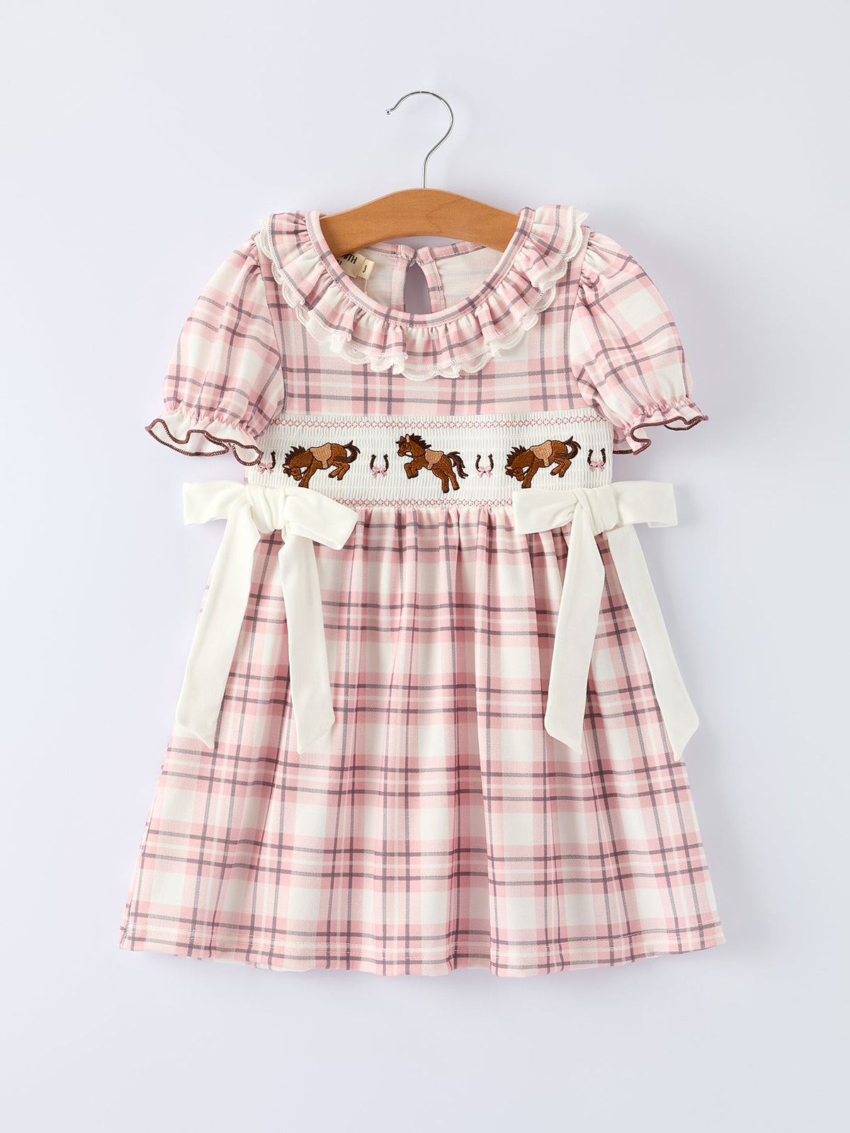 Pink plaid girls dress with smocked bodice, embroidered western horse detail, ruffled collar, and white side bows.