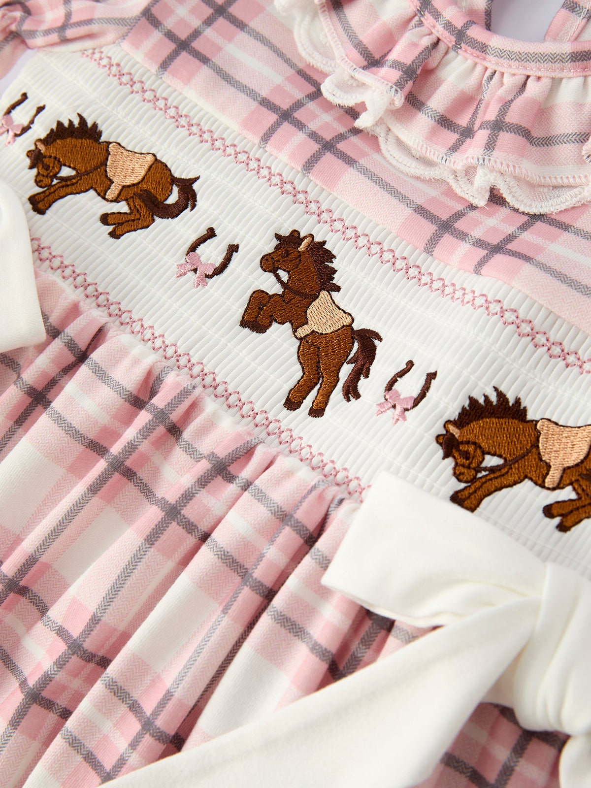 Western girls dress with pink plaid, smocked bodice featuring embroidered brown horses and horseshoes.