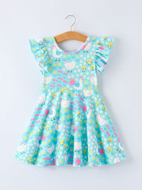 Girl twirling in the Aqua Spring Chicken Floral Farm Print Dress, enjoying a sunny day at the park.