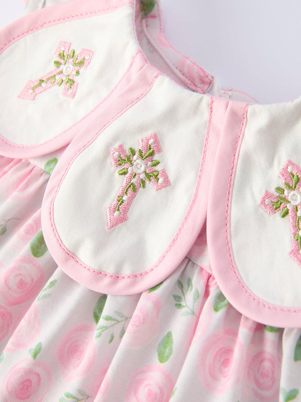 Two pink-edged bishop collars with pink cross embroidery and green leaves on a pastel floral dress.
