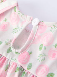 Pink floral baby bloomer set with gathered skirt and shoulder button detail.