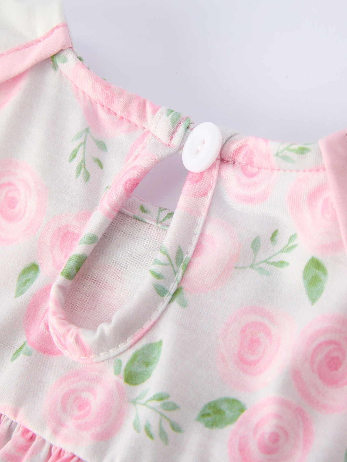 Pink floral smocked dress with a Peter Pan collar and back button closure.