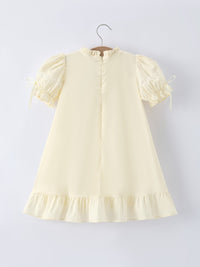 Soft beige embroidered design of the girls short sleeve dress, highlighting intricate details and comfort for warm days.