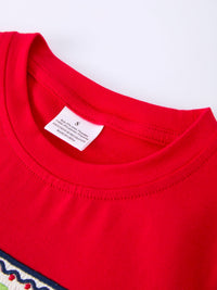 Close-up of a red kids' T-shirt neckline with a white care label