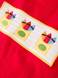 Crayon-embroidered smocked patch with pencils on red fabric, part of a boys back-to-school set.