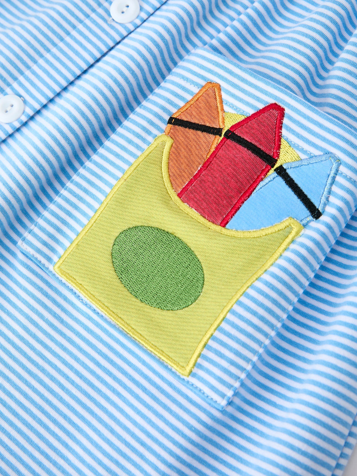 Detailed view of the colorful pencil appliqué pocket on the Girls Back To School Pencil Dress Petals Collar Pocket Applique, perfect for little treasures.
