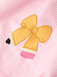 Highlighting the adorable bow applique on the Girls Back To School Pencil Twirl Dress, showcasing a pencil design in vibrant yellow against a pink checkered pattern.