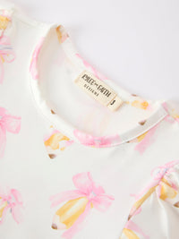 Pastel floral top from Girls Back To School Pencil Bow Pocket Ruffle Top Shorts Set, close-up of neckline and tag.