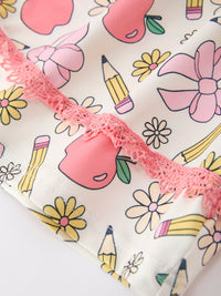 Close-up of girls' back-to-school Apple Pencil print fabric with pink lace trim from a dress and leggings set