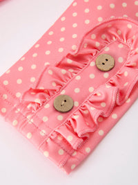 Pink polka-dot fabric with ruffled trim and wooden buttons from a girls back-to-school dress leggings set.