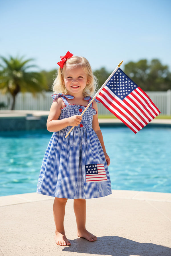 Children's dress with American flag patch on a white background