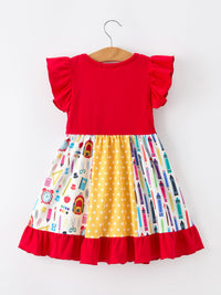 Girls Back To School Pencil Patchwork Twirl Dress with red bodice, ruffled sleeves, and colorful pencil print skirt.