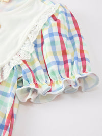 Pastel plaid twirl dress with white lace trim and ruffled cuffs.
