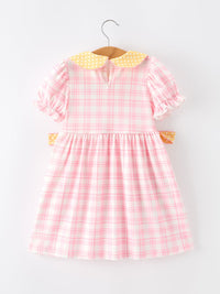 Pink pencil plaid twirl dress with yellow polka-dot collar on hanger