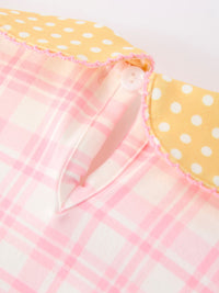 Pink pencil-plaid twirl dress with yellow polka-dot collar, pink trim, and button detail.