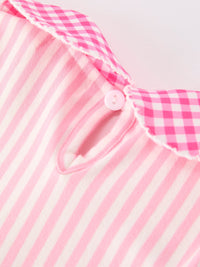 Close-up of pink striped fabric with a small pink button from the Girls Back To School Pink Plaid Petals Collar Pencil Applique Dress.