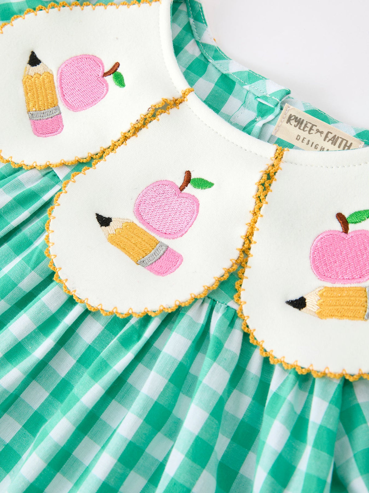 The Back to School Apple Pencil Applique Girls Dress displayed in a bright setting, ideal for making a stylish statement as a back to school dress.