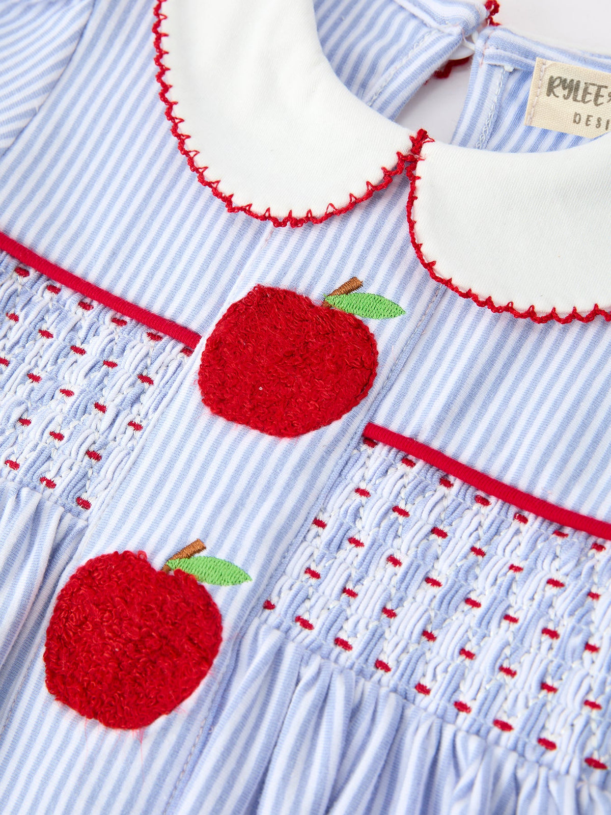 Display of the Adorable Girls Back to School Dress with Apple Chenille Patches & Petals Collar, highlighting the soft striped fabric and vibrant apple patches, great for back to school.